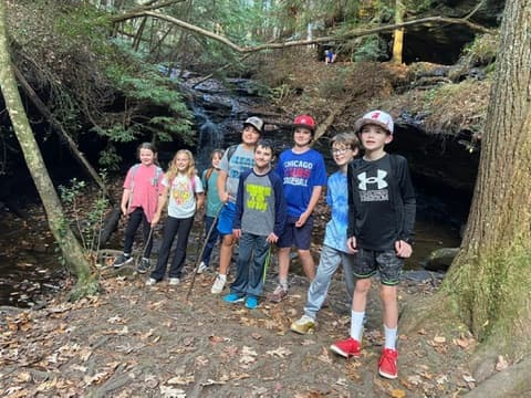 Kids hiking by a waterfall